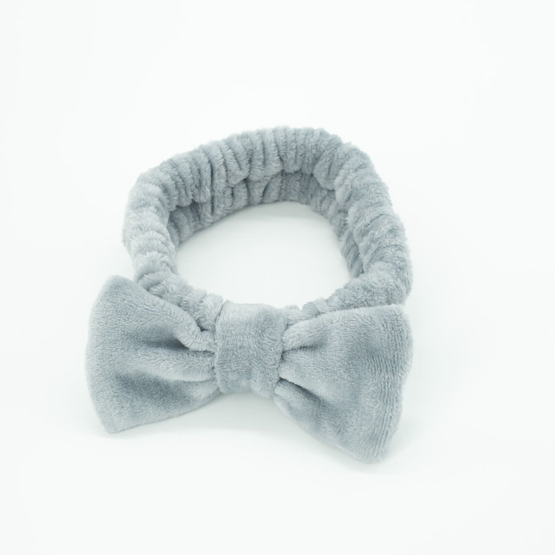 Bowknot Headband Grey: Plush headband with a stylish bow, ideal for holding hair in place during beauty routines, combining functionality and fashion.