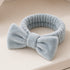 Bowknot Headband Grey: Plush headband with a stylish bow, ideal for holding hair in place during beauty routines, combining functionality and fashion.