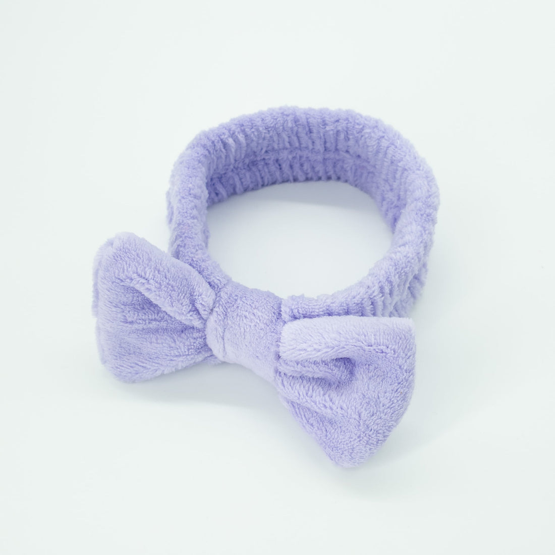 Bowknot Headband Purple: A plush, stylish headband with a bow, perfect for securing hair during beauty routines, blending functionality with fashion.
