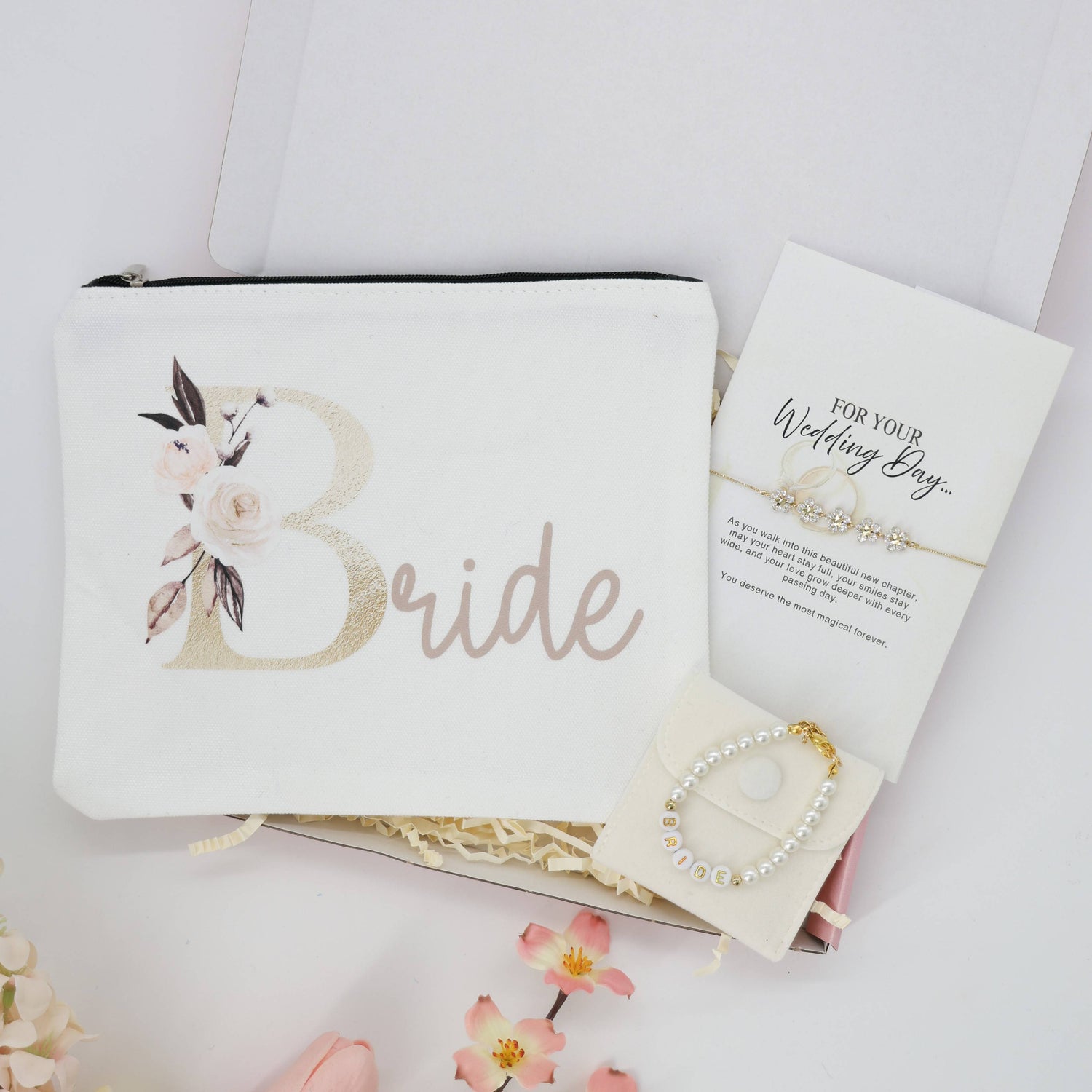 A Little Gift for the Bride | Bride To Be Gifts set with a floral pouch, pearl bracelet, and message card, elegantly arranged with floral accents.