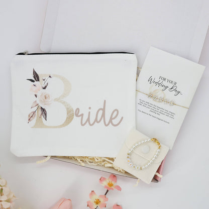 A Little Gift for the Bride | Bride To Be Gifts set with a floral pouch, pearl bracelet, and message card, elegantly arranged with floral accents.