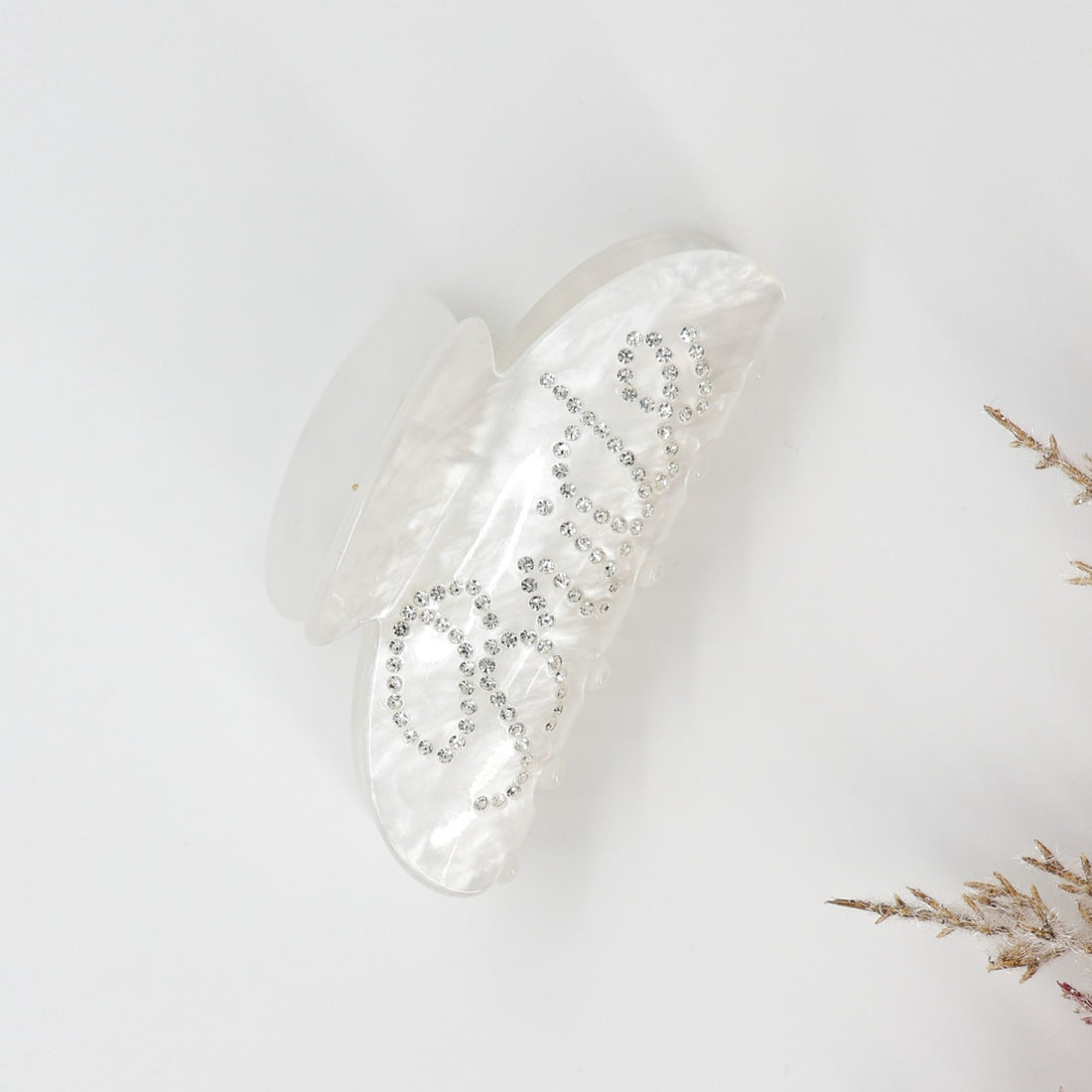 Bride Pearl Hair Clip: A glossy white hair clip with rhinestones spelling Bride, featuring an oversized claw design for elegant bridal or celebratory hairstyles.