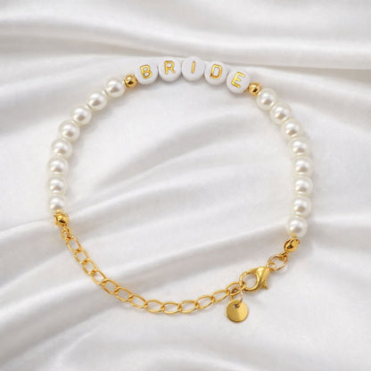 Bride Gold and Pearl Beaded Bracelet featuring glossy faux pearls and gold-lettered beads spelling “BRIDE,” perfect for bridal showers and pre-wedding celebrations.