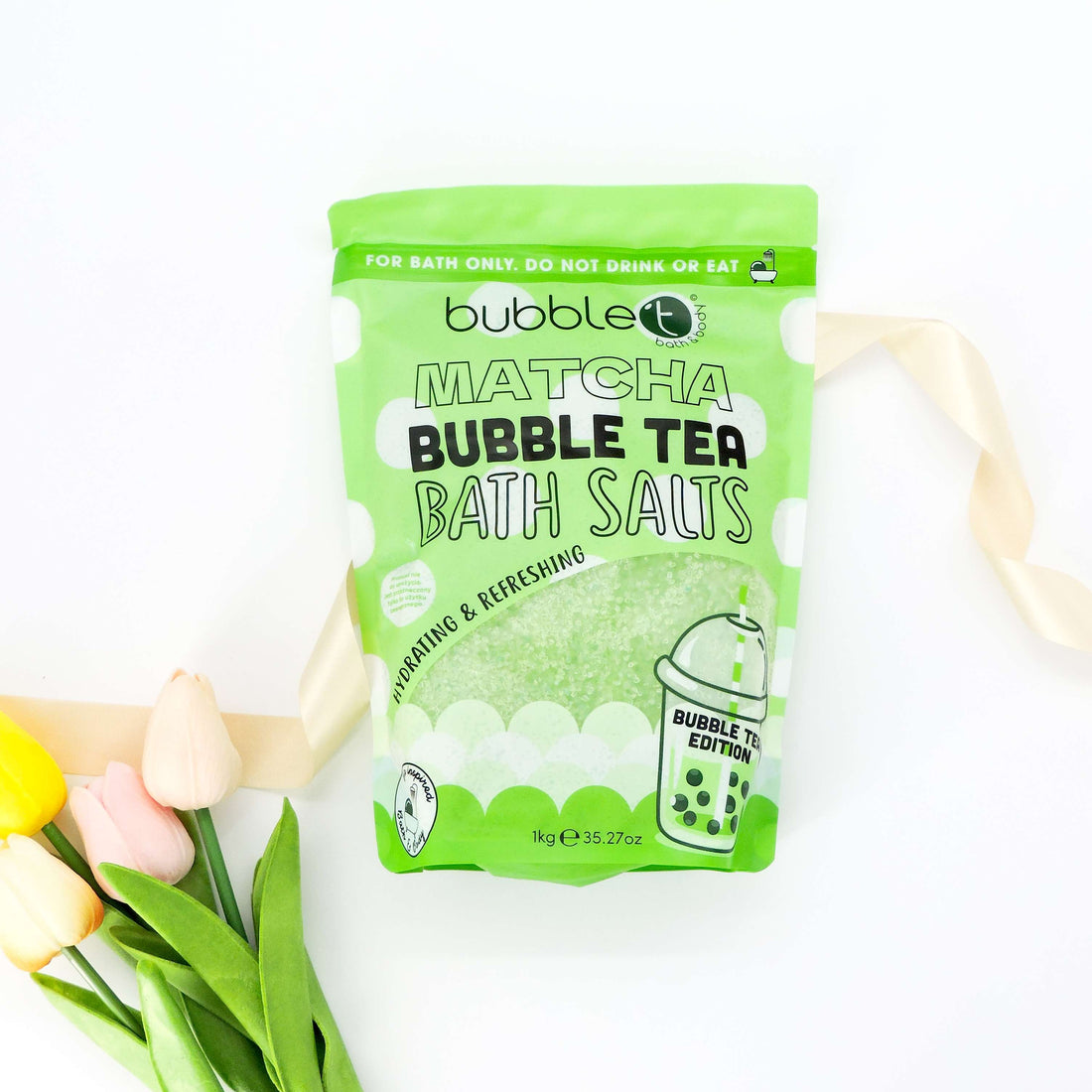 Bubble T Matcha Bath Salts packaging showcases close-up logo and text, highlighting its skin-hydrating and muscle-relaxing benefits for a luxurious bath experience.