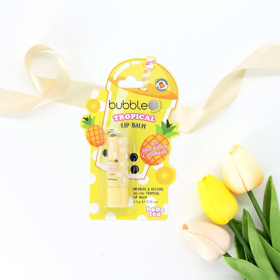 Bubble T Tropical Lip Balm with visible label, designed for easy application, offers moisturizing benefits with shea butter and jojoba oil for soft, hydrated lips.