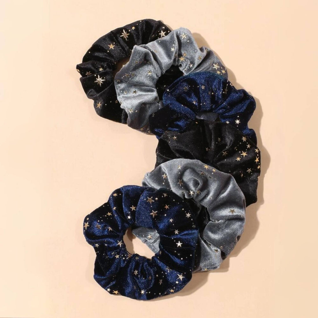 Celestial Velvet Scrunchie Set - 6 Pieces featuring velvet scrunchies with shimmering gold stars, ideal for adding a luxurious touch to hairstyles.