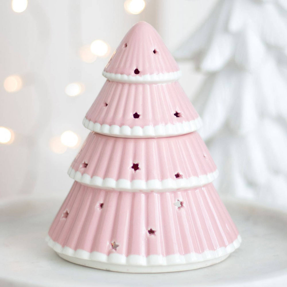 Christmas Tree Oil Burner with star cut-outs, serving as a stylish ornament. Use with diluted fragrance oil, lid removed, for festive home ambiance.