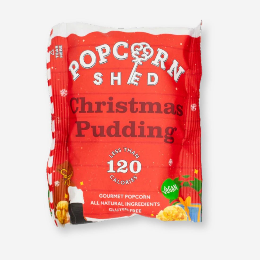 Christmas Pudding Popcorn, a festive snack blend of popped corn, sugar, and spices, showcasing its label and a pile of popcorn on a white surface.