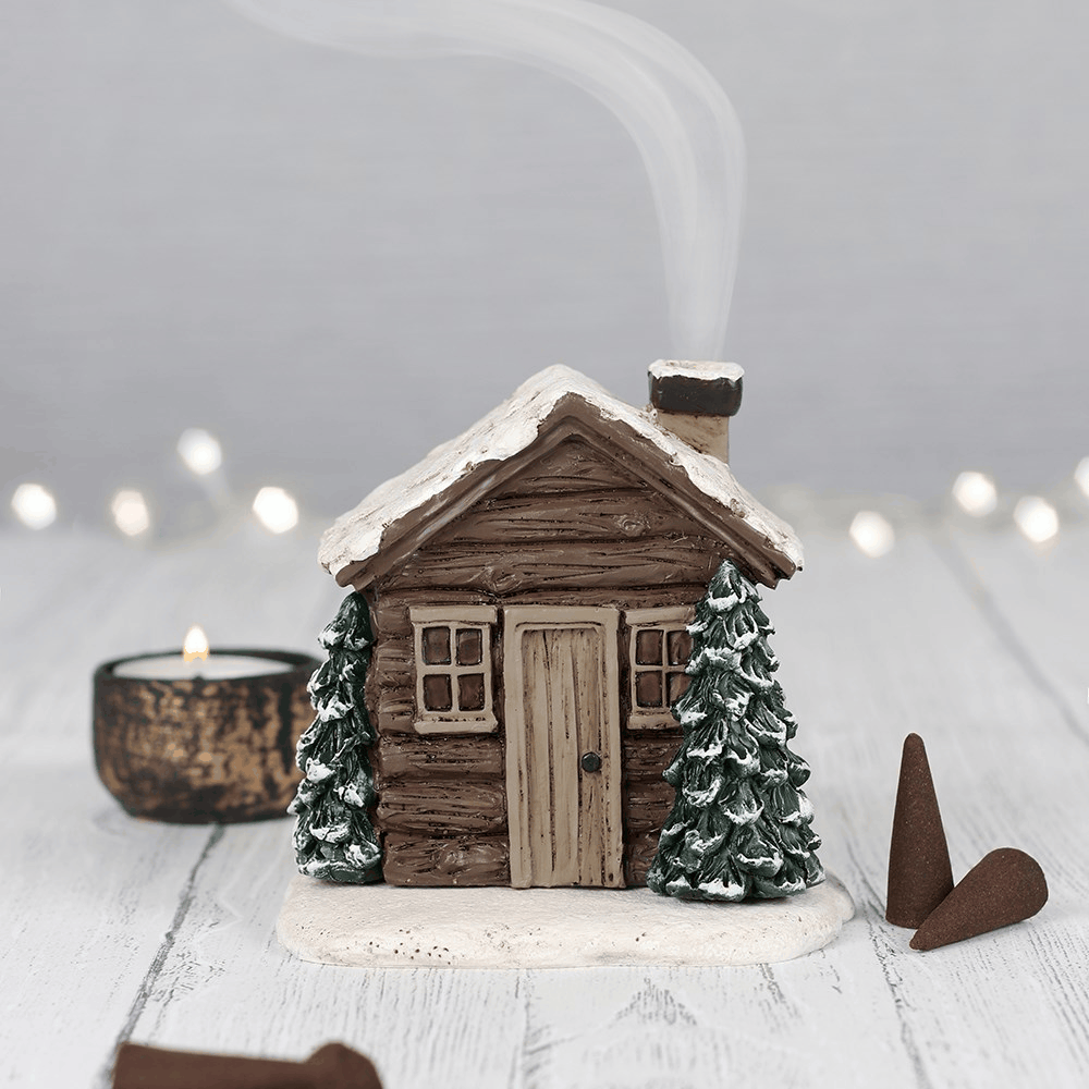 Log Cabin Incense Cone Burner featuring a snow-covered woodland cabin with smoke rising from the chimney