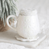 White ceramic snowflake mug with matching coaster and fluffy winter socks