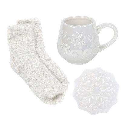 Cosy Christmas gift set featuring embossed snowflake mug, white coaster and soft socks