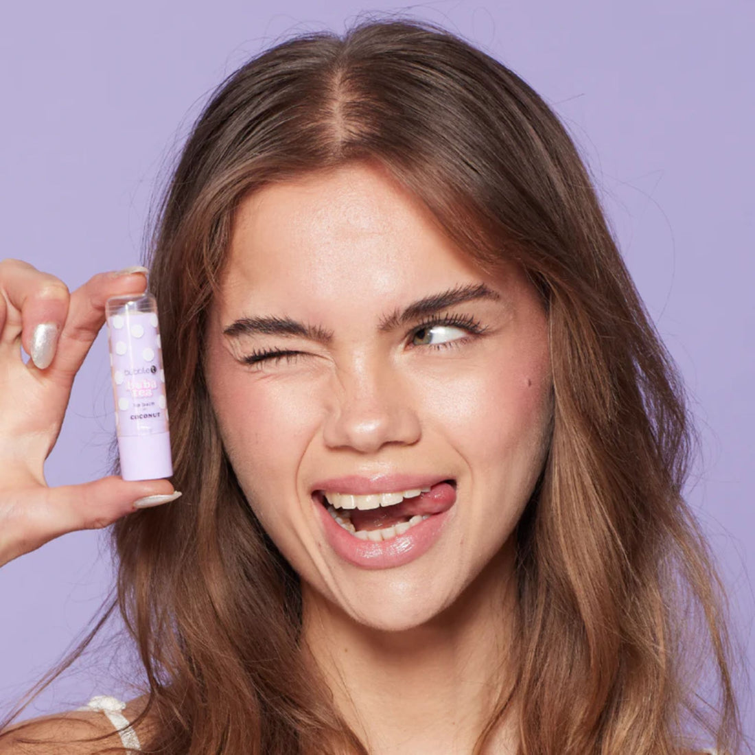 Coconut Lip Balm application close-up, highlighting hydrated, smooth lips with a subtle smile, enhanced by nourishing Shea Butter and Jojoba Oil formula.