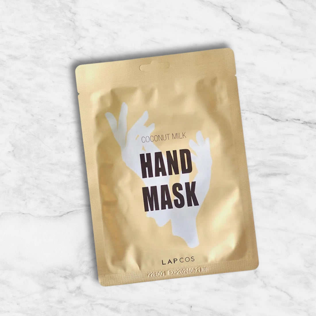 Coconut Milk Hand Mask on a white surface, designed to revitalize and hydrate hands with Ceramides and Coconut milk for improved elasticity and moisture.