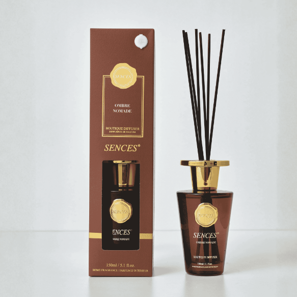 Corporate gifts featuring the Sences Ombre Nomade Reed Diffuser in an amber bottle with gold detailing.