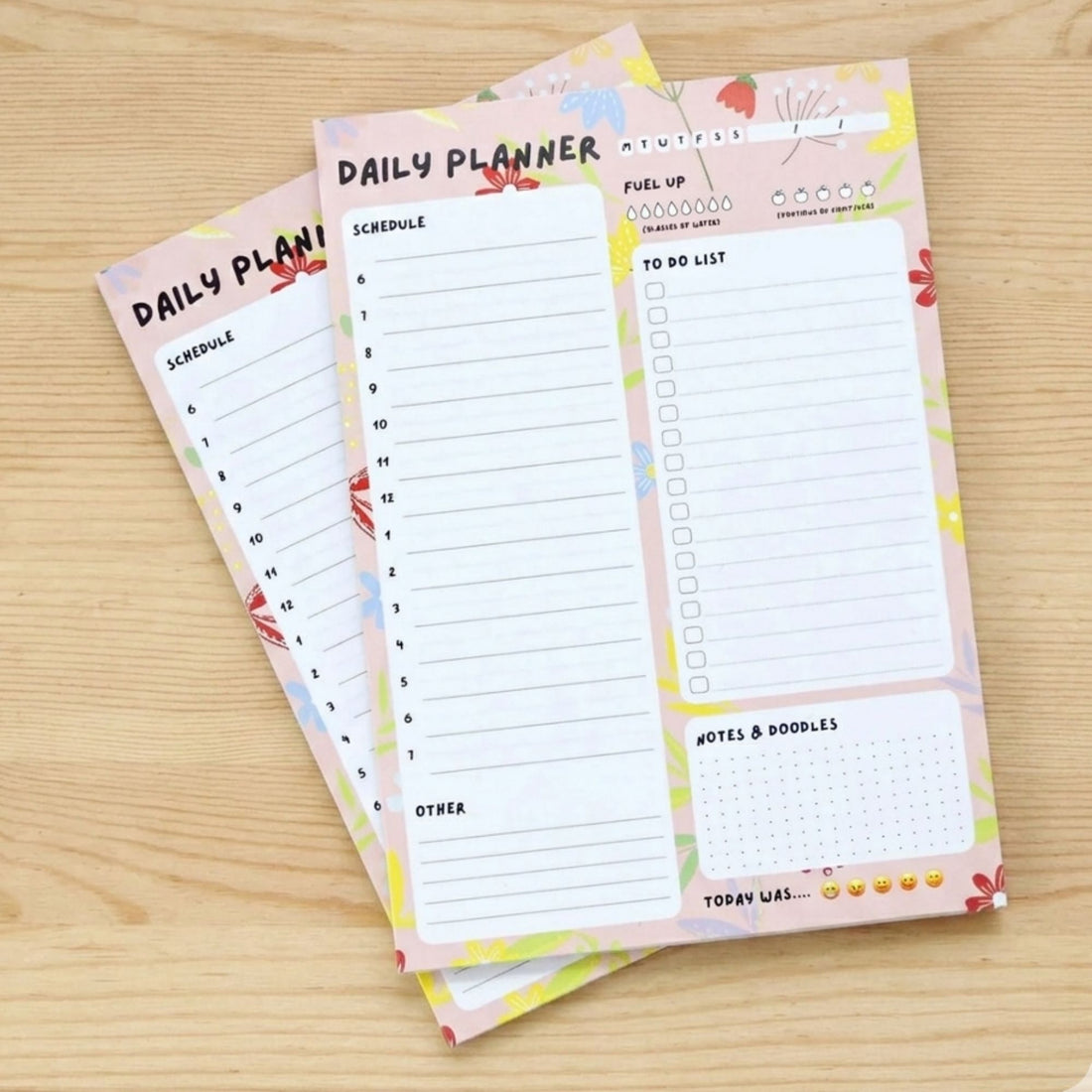 Daily Planner A5 Deskpad close-up showing floral layout with sections for scheduling, to-do lists, hydration tracking, and notes for enhanced organization.