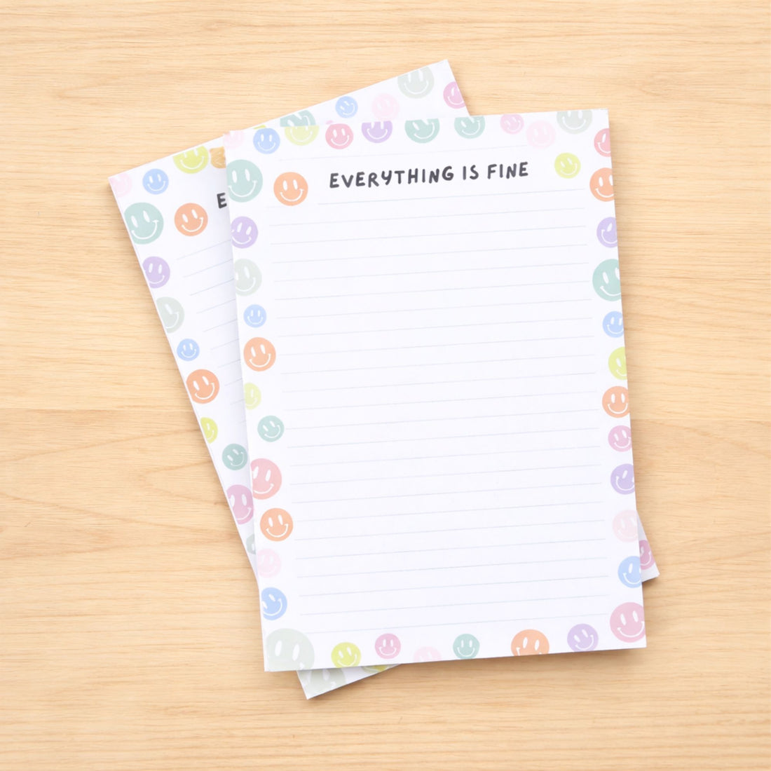 Everything is Fine A5 Deskpad with colorful smiley face border, ideal for notes and reminders, perfect for adding a cheerful touch to any workspace.
