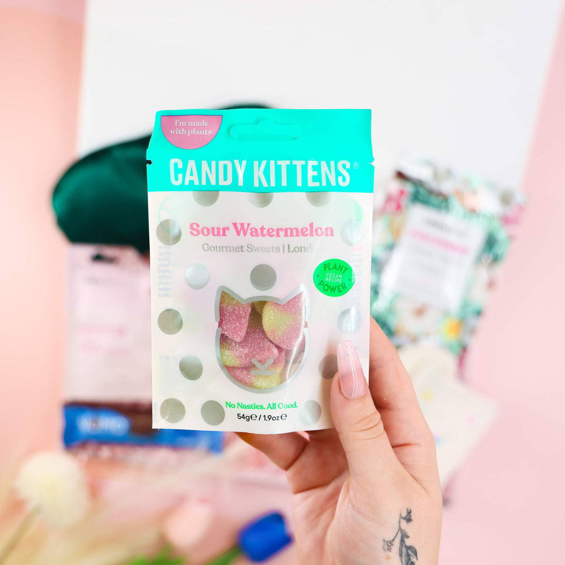 Feel-Good Care Package detail—Candy Kittens Sour Watermelon vegan sweets held in hand, part of a self-care gift box.