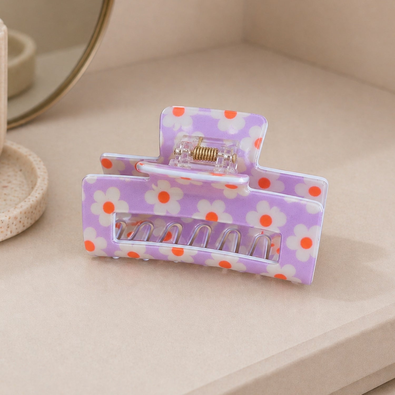 Purple Floral Print Hair Clip showcasing vibrant floral patterns with a sturdy grip, ideal for adding color to any hairstyle.