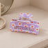 Purple Floral Print Hair Clip showcasing vibrant floral patterns with a sturdy grip, ideal for adding color to any hairstyle.