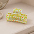 Chartreuse Floral Print Hair Clip showcasing vibrant floral patterns with a sturdy grip, ideal for adding color to any hairstyle.