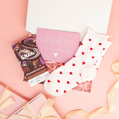 get well soon gift – small pink treat box with cosy socks and chocolate brownie bar