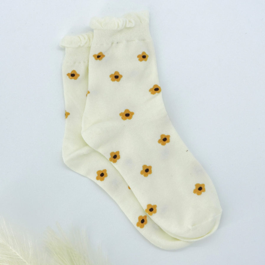 Daisy Dots Socks featuring tiny golden daisy patterns and a gentle ruffle trim for a charming, cozy look, ideal for any casual or gift occasion.