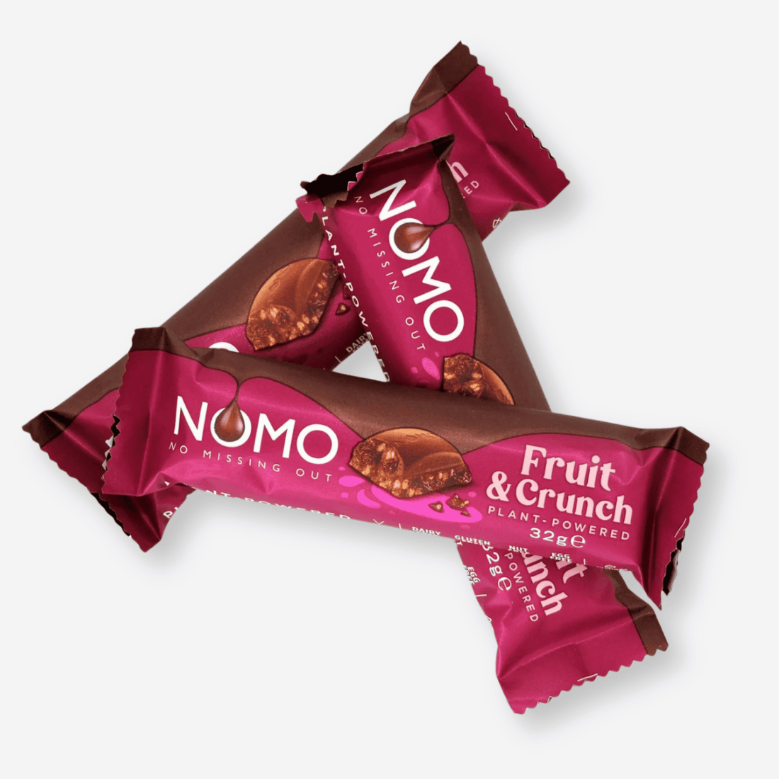 NOMO Fruit &amp; Crunch Choc Bar close-up, highlighting the pink label and texture, showcasing its vegan, dairy-free, gluten-free, nut-free attributes for an allergen-friendly treat.