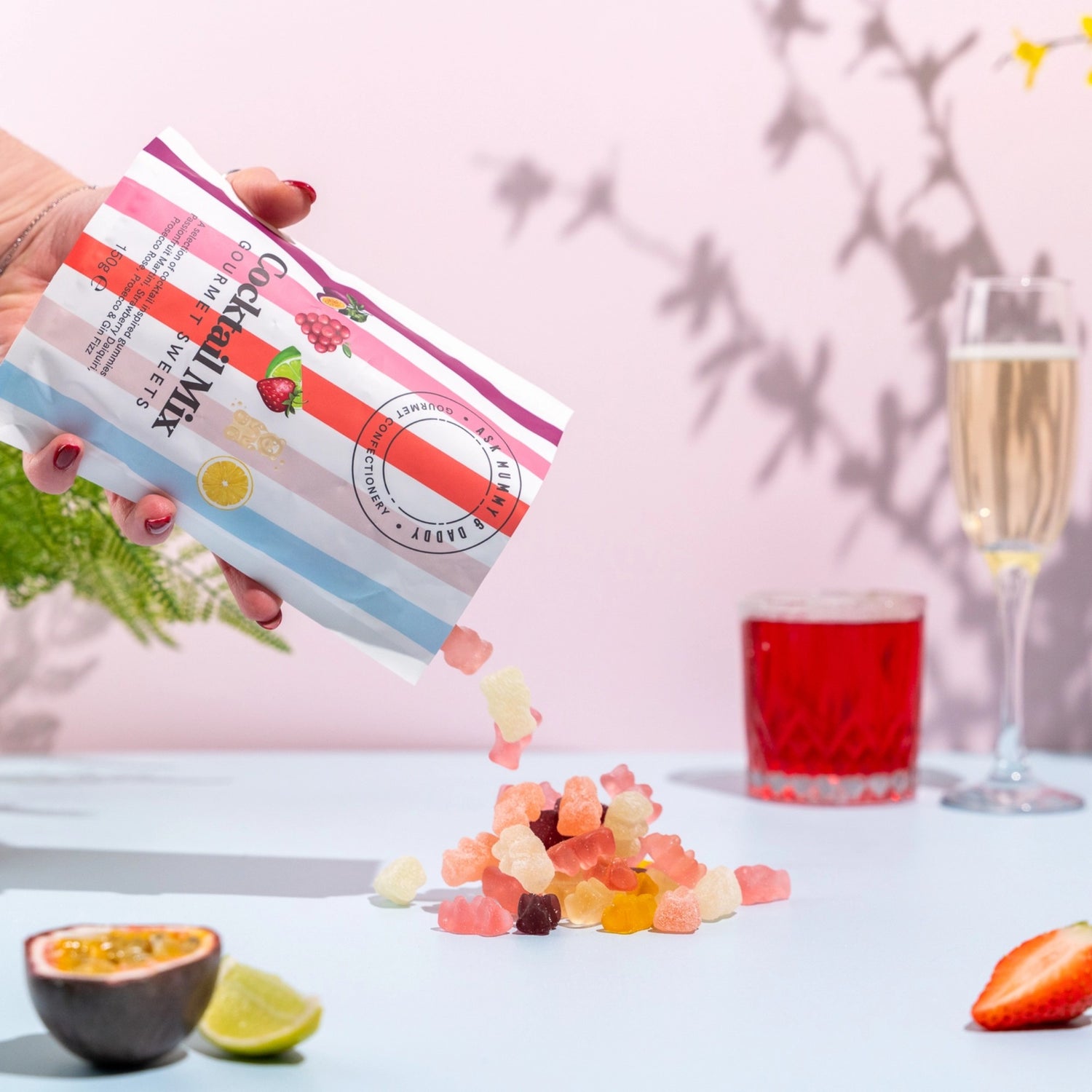 Gifts for her – vibrant gourmet sweets with mixed fruit gummies styled with cocktail drinks and glassware