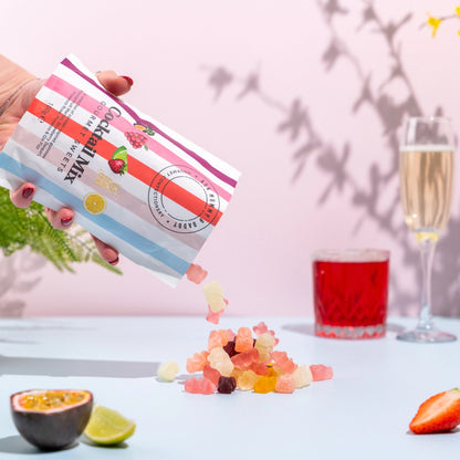 Gifts for her – vibrant gourmet sweets with mixed fruit gummies styled with cocktail drinks and glassware