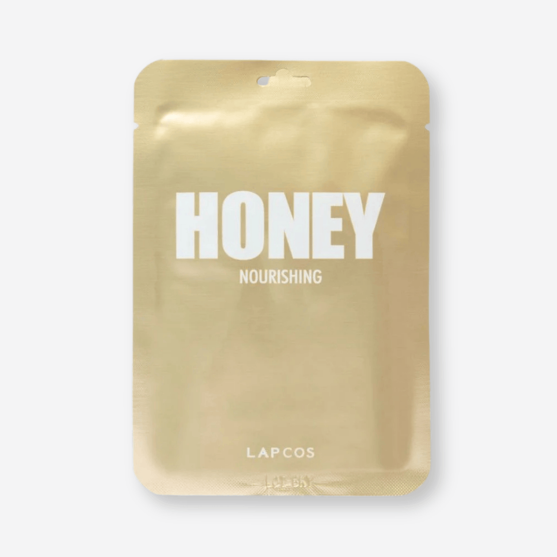 Honey Nourishing Mask label close-up on a brown surface, highlighting its skin-moisturizing and antibacterial benefits for treating acne, eczema, and psoriasis.