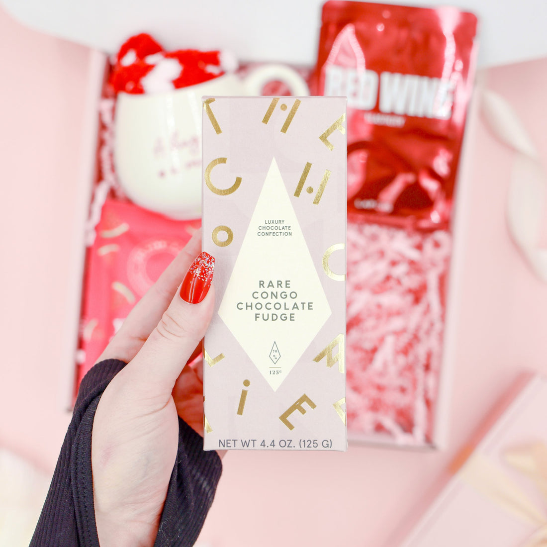 Red Velvet Treats exclusive luxury gift for her with Rare Congo chocolate fudge, red wine face mask, mug, cosy socks and self-care treats.