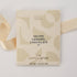 The Chocolatier Salted Caramel Chocolate bar in elegant cream packaging with abstract shapes and pale gold ribbon, perfect for gifting and indulgence.