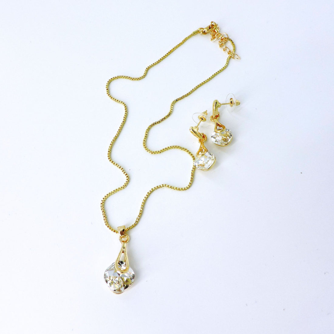 Gold-Plated Crystal Pendant Jewelry Set featuring a close-up of a radiant gold chain and sparkling diamond earrings, ideal for special occasions or cherished gifts.