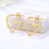 Gold Heart Earrings Charm with sleek open-heart design and hook fastening, offering a chic, elegant touch for gifting or everyday wear.