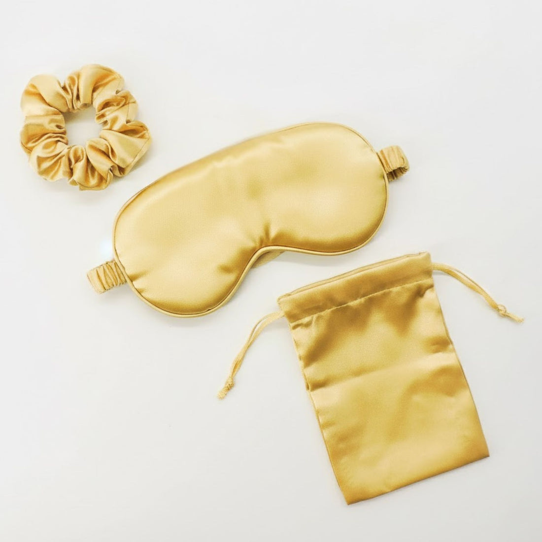 Gold Satin Eye Mask &amp; Hair Scrunchie Set featuring a silky eye mask and matching scrunchie, perfect for relaxation and travel.