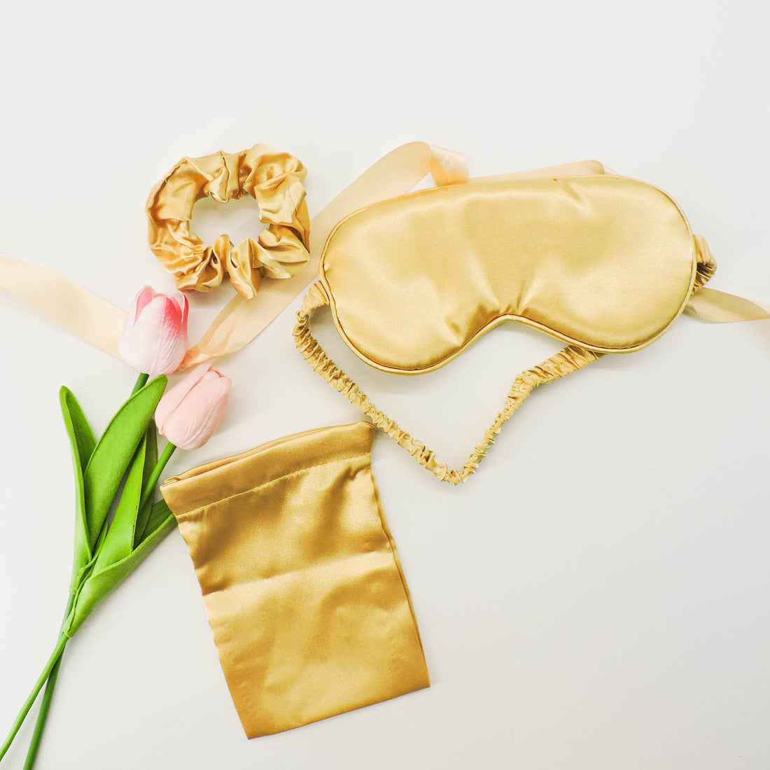 Gold Satin Eye Mask &amp; Hair Scrunchie Set featuring a silky eye mask and matching scrunchie on a white surface, perfect for relaxation and travel.