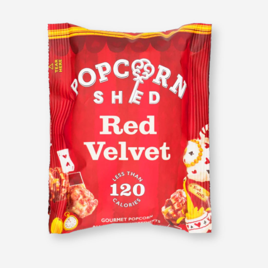 Popcorn Shed Red Velvet: A red bag of red velvet cake-flavored popcorn with visible white chocolate pieces and cream cheese frosting.