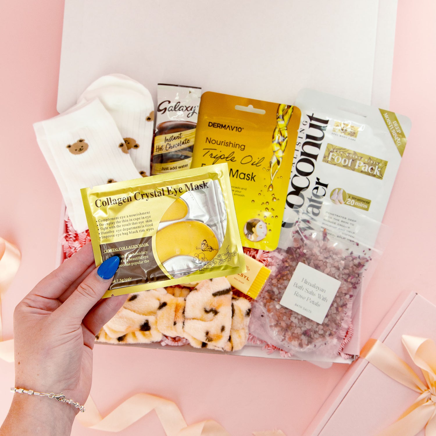 Luxury self care gift for her featuring collagen eye mask, bath salts, hot chocolate, cozy socks and spa treats – perfect relaxation gift box.