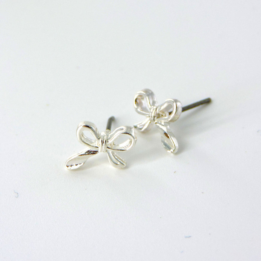 Japanese Bow Silver Earrings featuring a minimalist sterling silver design with elegant bow-shaped details, perfect for adding timeless style to any outfit.