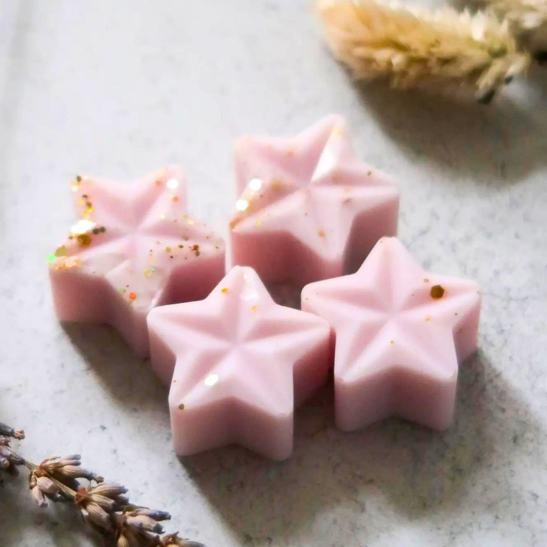 Lavender Wax Melt shaped like pink stars, offering a relaxing blend of eucalyptus, bergamot, patchouli, and tonka, enhancing gift boxes with serenity.
