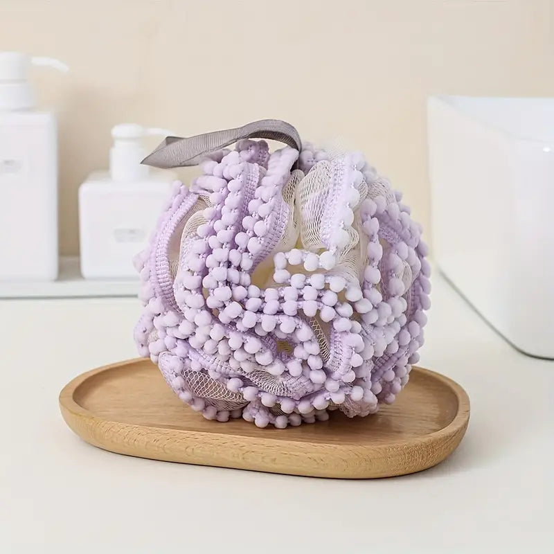 Luxury Loofah - Purple: A close-up of a textured bath loofah designed for gentle exfoliation, enhancing your bathing experience with a rich, luxurious lather.
