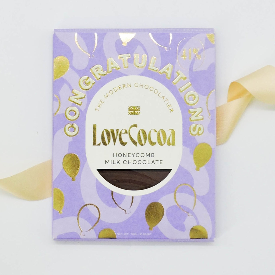Love Cocoa Congratulations Chocolate features a luxe package with a yellow ribbon and label, containing buttery biscuits with chocolate chunks in milk chocolate.