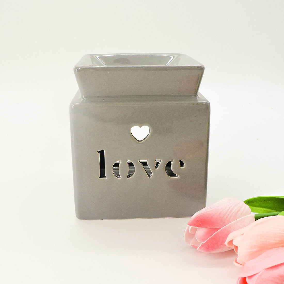 Love Tealight Holder &amp; Oil Burner, a ceramic piece shaped like a heart, doubles as a tealight holder and aromatherapy oil burner for stylish home decor.