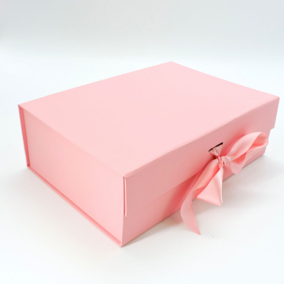 Luxury Pink box adorned with a bow, ideal for gifting or elegant storage.
