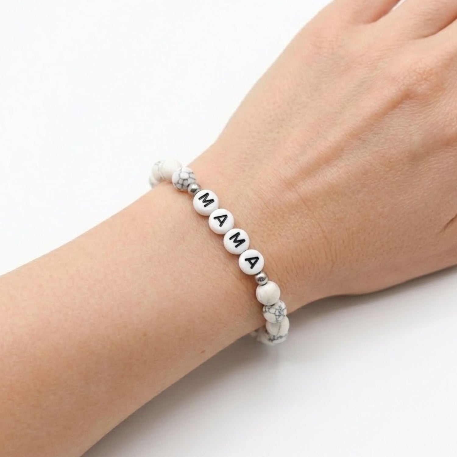 Mama Bracelet with white marbled beads and black letter charms, designed as a stretch-fit fashion accessory celebrating motherhood. Ideal gift for moms and mothers-to-be.
