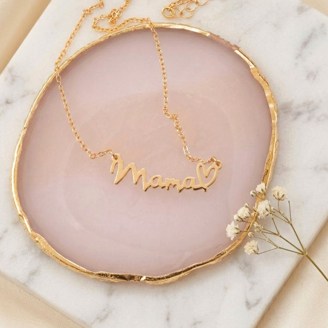 Mama Necklace with Heart: A close-up of a gold necklace featuring a Mama pendant and a delicate heart charm, symbolizing love and appreciation for mothers.