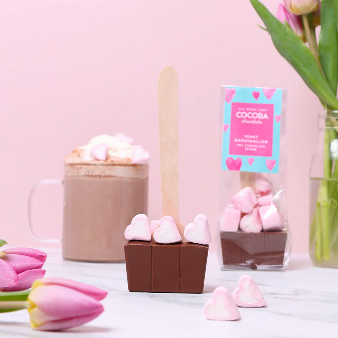 Milk Chocolate Spoon With Heart Marshmallows, featuring Belgian chocolate adorned with heart-shaped marshmallows for a luxurious hot cocoa experience.