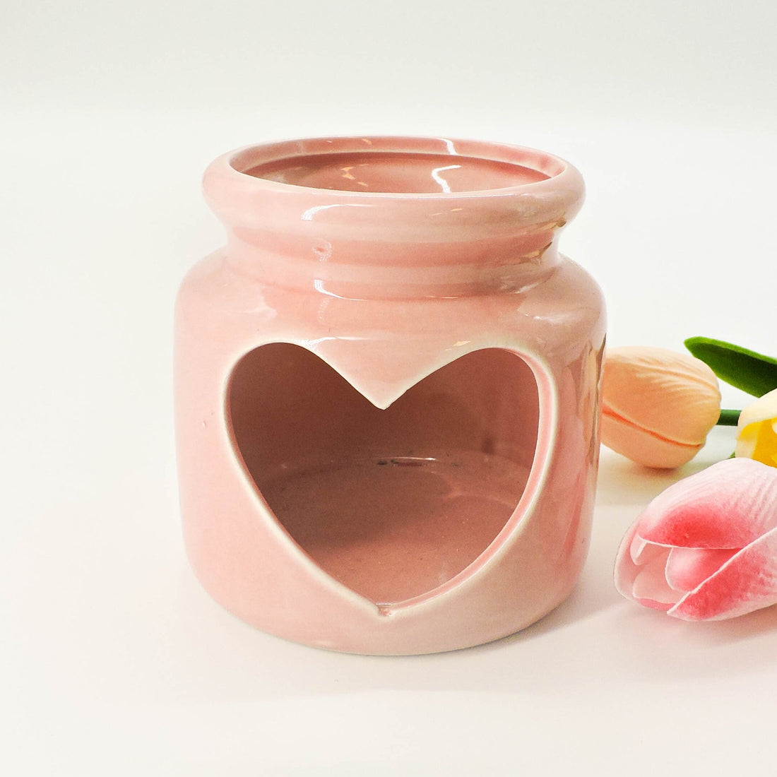 Pink Heart Tealight Holder in ceramic with a heart cutout, designed to add a romantic and cozy ambiance to home spaces.