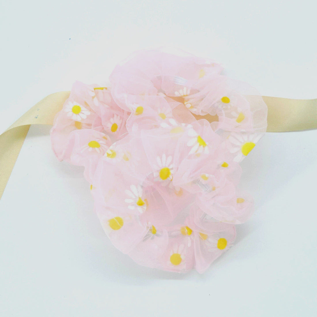 Daisy Hair Scrunchie - Pink: A soft, floral scrunchie adorned with daisy patterns, ideal for adding a feminine touch to hairstyles or as a wrist accessory.