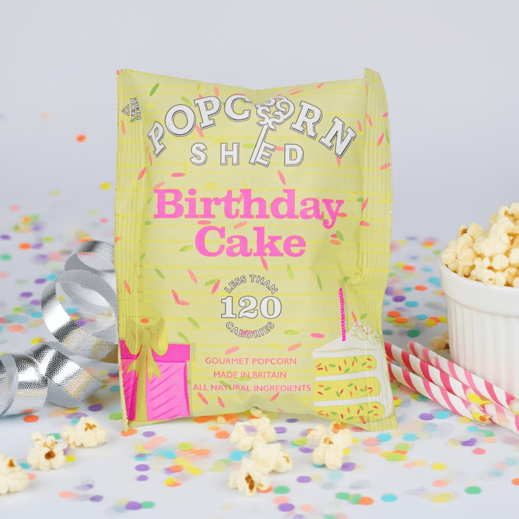 Birthday Cake Popcorn Bonanza, a festive snack featuring popped corn with sugar strands and white chocolate, perfect for celebratory occasions. Vegetarian-friendly ingredients.
